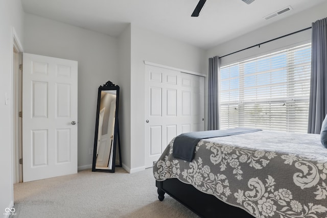 bedroom with visible vents, carpet floors, a closet, baseboards, and ceiling fan