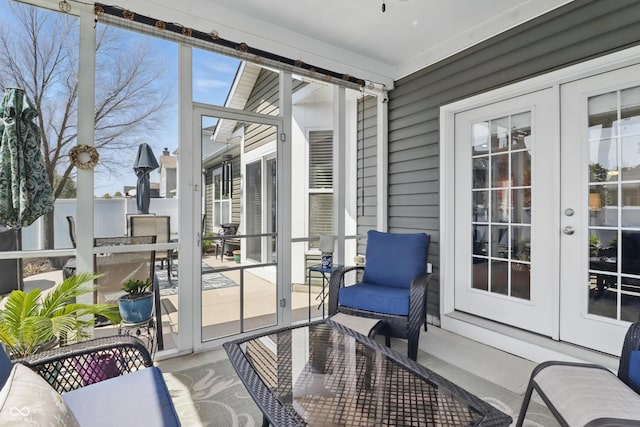 sunroom / solarium featuring french doors