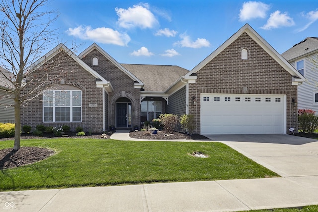ranch-style home with a garage, concrete driveway, a front lawn, and brick siding