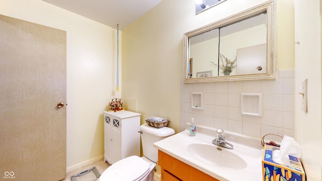 half bathroom featuring vanity and toilet