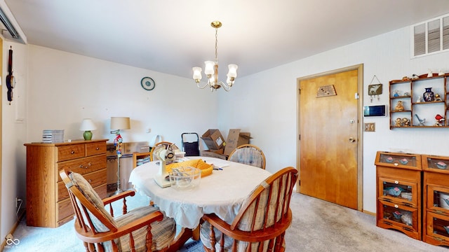 carpeted dining room featuring an inviting chandelier and visible vents