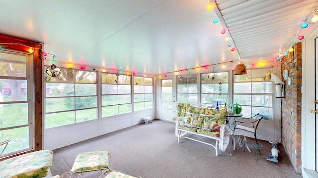 sunroom / solarium featuring carpet flooring