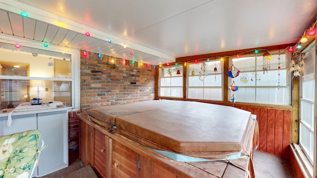 sunroom featuring a jacuzzi