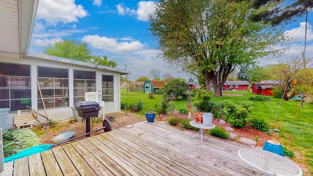 wooden deck with a lawn, a sunroom, and area for grilling