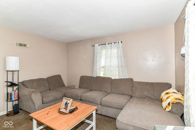 living area featuring carpet floors, baseboards, and visible vents
