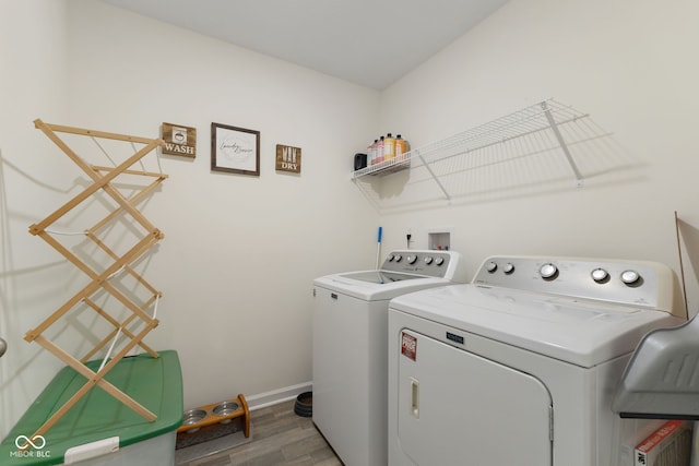 5845 Cresswell Ln, Whitestown, IN 46075 - laundry room featuring washing machine and dryer, wood finished floors, and baseboards