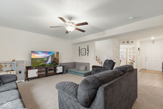 5845 Cresswell Ln, Whitestown, IN 46075 - living room with carpet flooring, stairway, and a ceiling fan