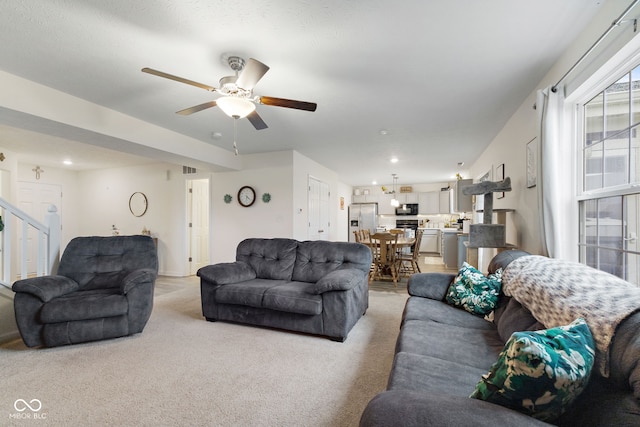 5845 Cresswell Ln, Whitestown, IN 46075 - living room featuring light carpet, a ceiling fan, recessed lighting, and stairs