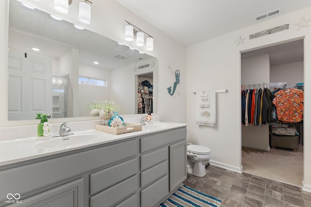 5845 Cresswell Ln, Whitestown, IN 46075 - full bath with double vanity, a walk in closet, toilet, and baseboards