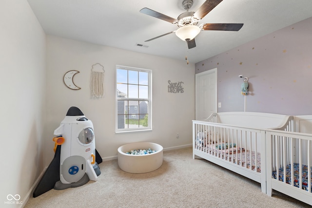 5845 Cresswell Ln, Whitestown, IN 46075 - bedroom with carpet floors, a crib, baseboards, and a ceiling fan