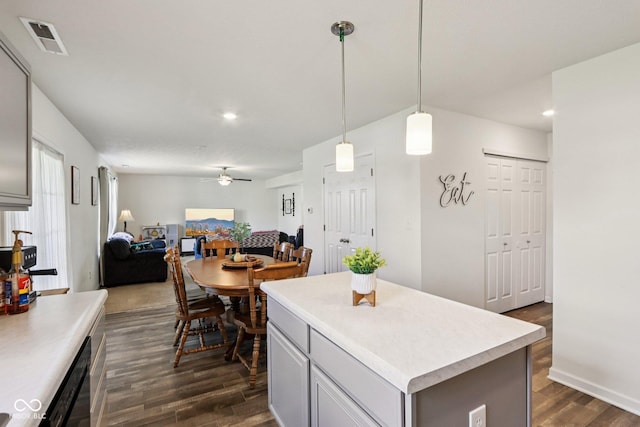 5845 Cresswell Ln, Whitestown, IN 46075 - kitchen featuring a ceiling fan, dark wood finished floors, light countertops, open floor plan, and a center island