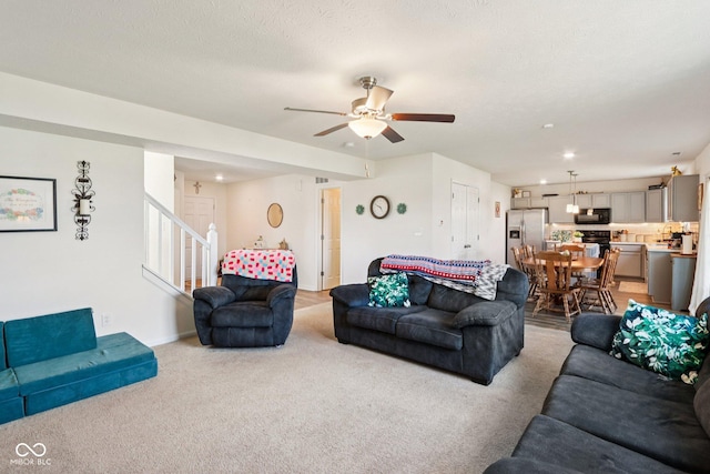 5845 Cresswell Ln, Whitestown, IN 46075 - living area featuring light carpet, stairway, and a ceiling fan