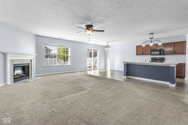 5465 Tanglewood Ln, Whitestown, IN 46075 - unfurnished living room featuring a fireplace, baseboards, ceiling fan, light colored carpet, and a sink