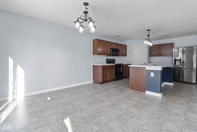 5465 Tanglewood Ln, Whitestown, IN 46075 - kitchen featuring light countertops, pendant lighting, a notable chandelier, and black appliances