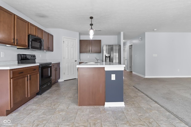 5465 Tanglewood Ln, Whitestown, IN 46075 - kitchen featuring a sink, light countertops, black appliances, and a center island with sink