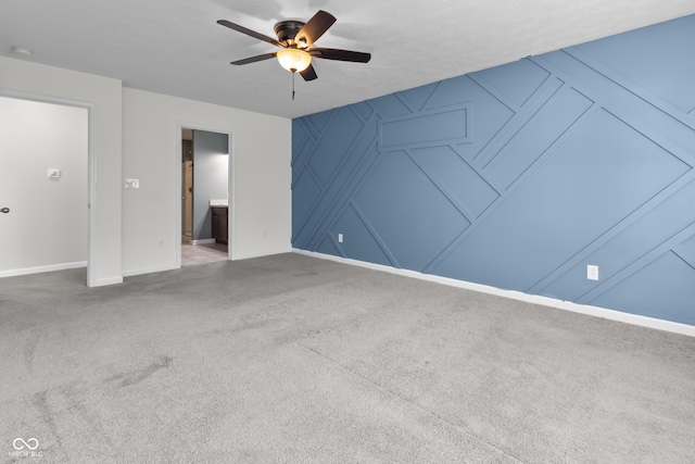5465 Tanglewood Ln, Whitestown, IN 46075 - carpeted empty room with a ceiling fan, baseboards, and a decorative wall