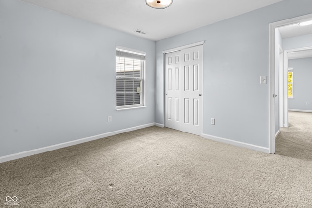 5465 Tanglewood Ln, Whitestown, IN 46075 - unfurnished bedroom featuring carpet floors, baseboards, visible vents, and a closet