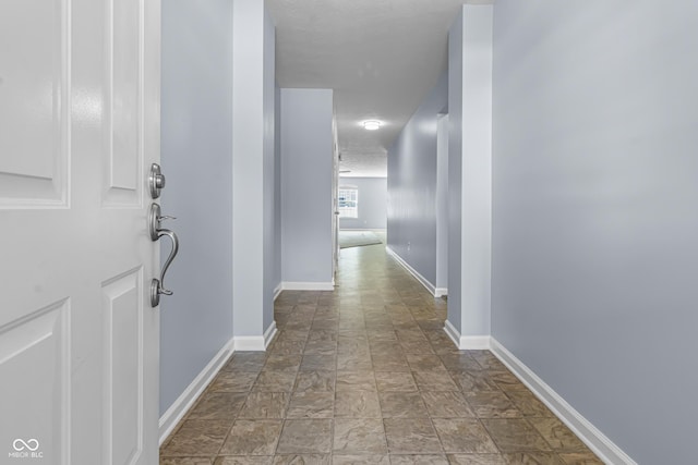 5465 Tanglewood Ln, Whitestown, IN 46075 - hallway featuring baseboards and stone finish floor