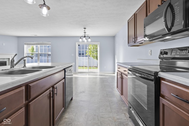 5465 Tanglewood Ln, Whitestown, IN 46075 - kitchen with light countertops, plenty of natural light, a sink, and black appliances