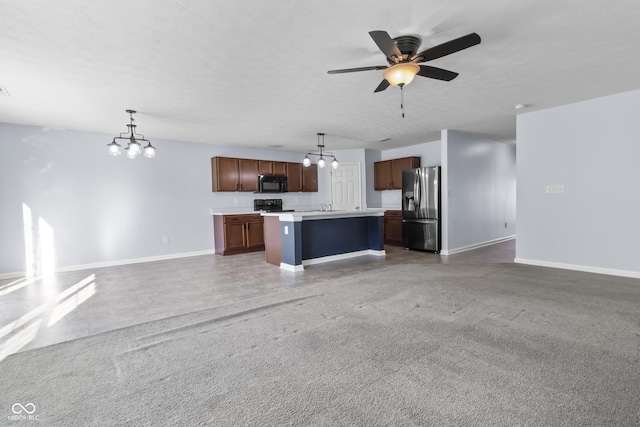 5465 Tanglewood Ln, Whitestown, IN 46075 - unfurnished living room with baseboards, a sink, and ceiling fan with notable chandelier