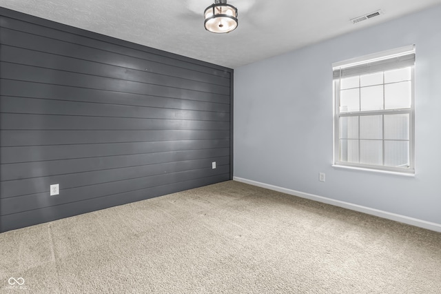 5465 Tanglewood Ln, Whitestown, IN 46075 - unfurnished room featuring visible vents, carpet, baseboards, and wooden walls