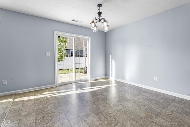 5465 Tanglewood Ln, Whitestown, IN 46075 - spare room featuring visible vents, baseboards, stone finish floor, and an inviting chandelier