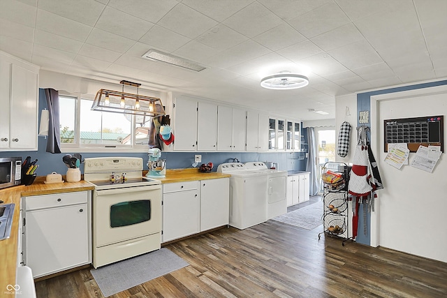 kitchen featuring white cabinets, separate washer and dryer, and white range with electric stovetop