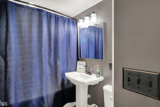 full bath with a shower with curtain and toilet