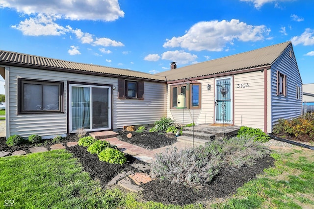 ranch-style house featuring metal roof