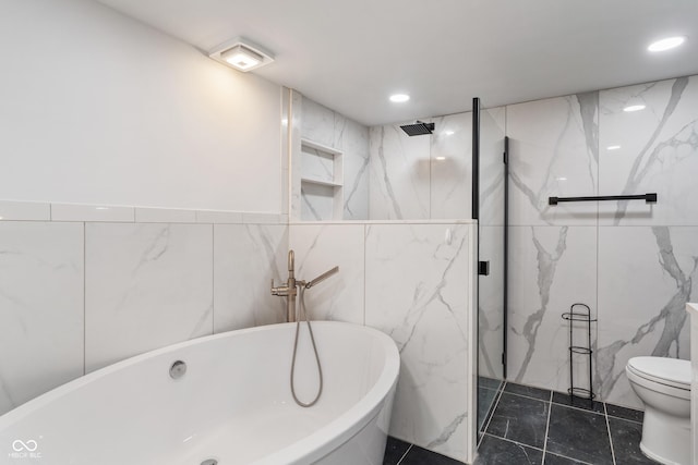 2263 N Rural St, Indianapolis, IN 46218 - bathroom with tile walls, a freestanding bath, a marble finish shower, toilet, and recessed lighting