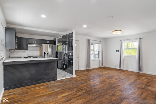 2263 N Rural St, Indianapolis, IN 46218 - kitchen with stainless steel refrigerator with ice dispenser, a sink, wood finished floors, under cabinet range hood, and backsplash