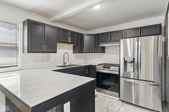 2263 N Rural St, Indianapolis, IN 46218 - kitchen with stainless steel appliances, a sink, a peninsula, under cabinet range hood, and light stone counters