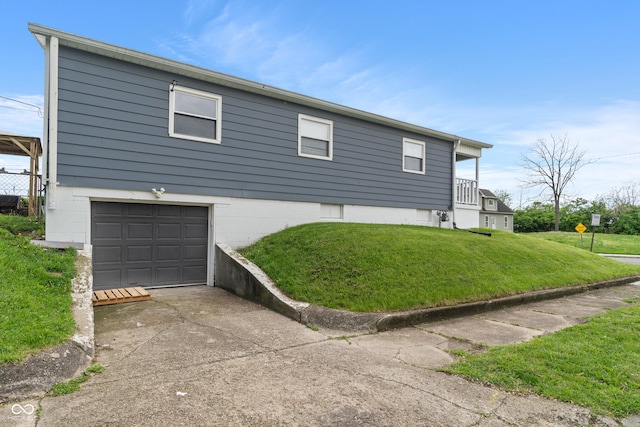 2263 N Rural St, Indianapolis, IN 46218 - view of property exterior featuring concrete driveway, a garage, and a yard