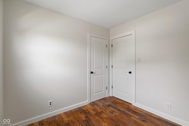 2263 N Rural St, Indianapolis, IN 46218 - unfurnished room with baseboards and dark wood-style floors