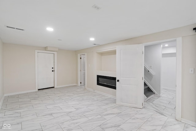 2263 N Rural St, Indianapolis, IN 46218 - finished basement with a glass covered fireplace, recessed lighting, stairway, light marble finish floors, and baseboards