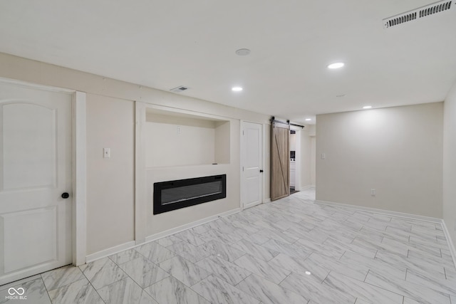 2263 N Rural St, Indianapolis, IN 46218 - finished below grade area featuring a barn door, recessed lighting, baseboards, and a glass covered fireplace
