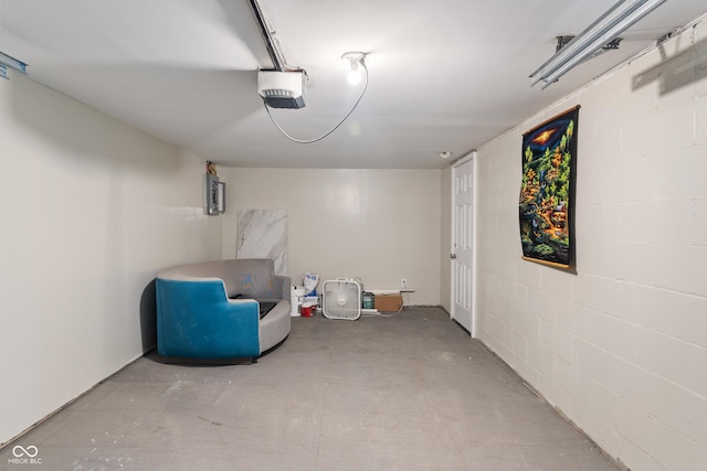 2263 N Rural St, Indianapolis, IN 46218 - garage featuring a garage door opener and concrete block wall