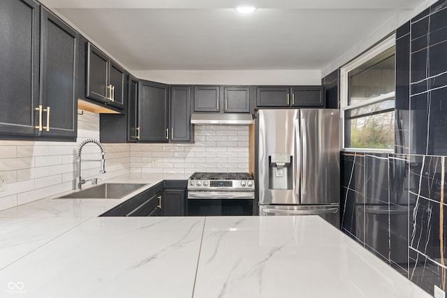 2263 N Rural St, Indianapolis, IN 46218 - kitchen with stainless steel appliances, a sink, under cabinet range hood, and light stone countertops