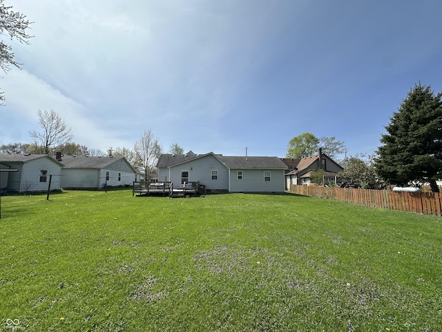 view of yard with a deck and fence