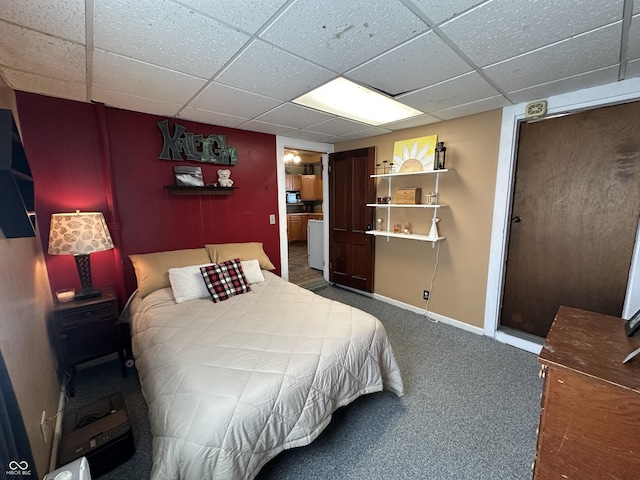 carpeted bedroom with baseboards and a paneled ceiling