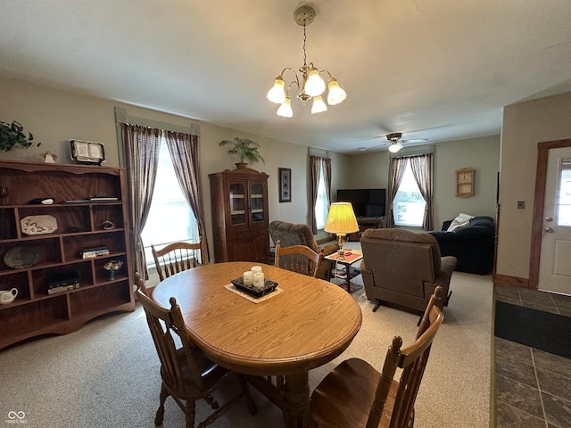 dining area featuring carpet floors and a notable chandelier