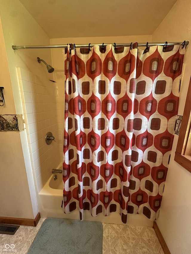 full bath with baseboards, tile patterned flooring, shower / bath combo with shower curtain, and visible vents