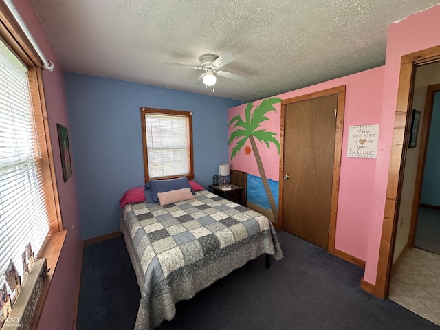 carpeted bedroom featuring baseboards, ceiling fan, a closet, and a textured ceiling