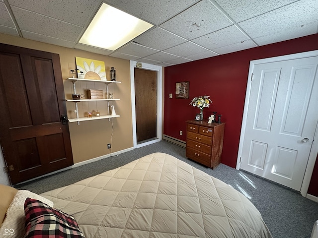 carpeted bedroom featuring baseboards, a baseboard heating unit, and a drop ceiling