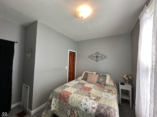 bedroom with baseboards, carpet flooring, and visible vents