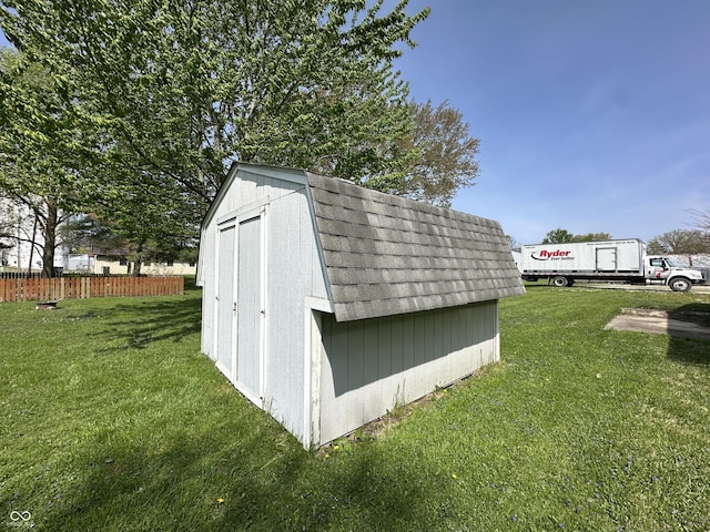 view of shed featuring fence