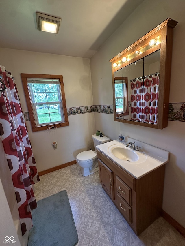 bathroom featuring toilet, visible vents, a wealth of natural light, and vanity