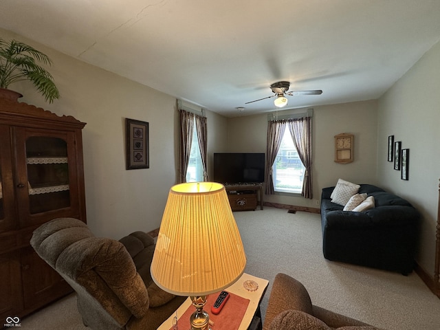 living room featuring a ceiling fan and light colored carpet