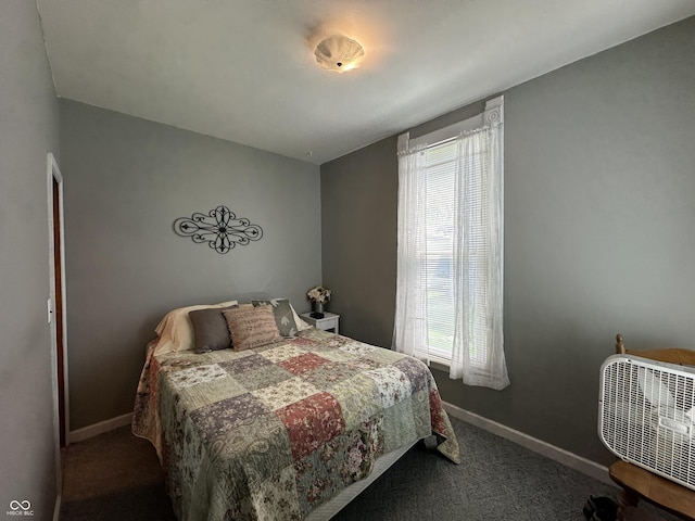 bedroom featuring baseboards and carpet flooring