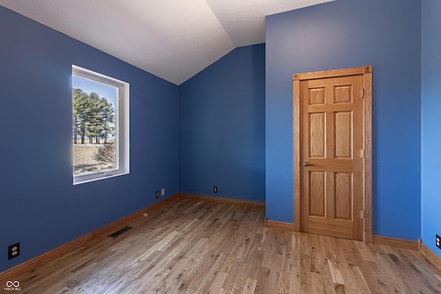 bonus room with baseboards, visible vents, wood finished floors, and lofted ceiling